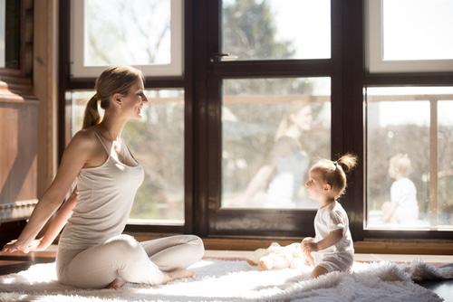 mother at Easy Seat pose cute baby daughter sitting near her