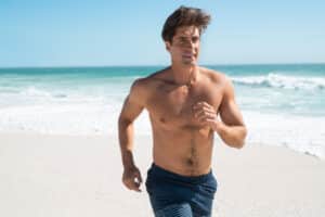 Fit,Man,Jogging,On,The,Beach.,Mid,Adult,Fitness,Man