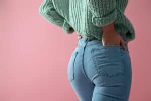 Woman's shapely buttocks in jeans after BBL